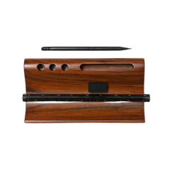 A hand-carved taksh desk organizer made from reclaimed teak wood, with slots for holding various stationery items.