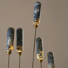 Outdoor floor lamp with set of decorative sticks with marbled green and gold design 