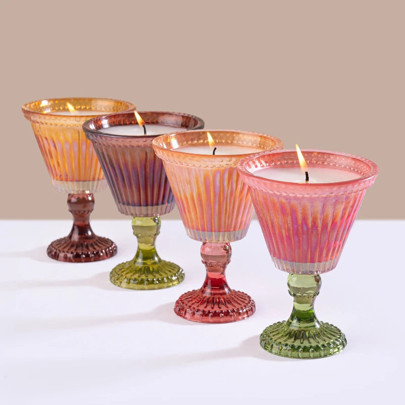 Sundae Votive Candles in amber, plum, peach and petal pink, four ribbed sundae glasses lit in a row