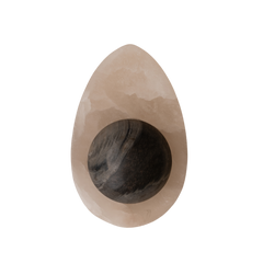 Modern alabaster wall sconce with black marble base mounted on wall