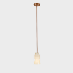 A rose gold pendant light with a white alabaster glass shade, suspended by a sleek steel column.