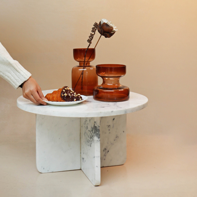 Decorative brown glass vase containing a bouquet of artificial flowers
