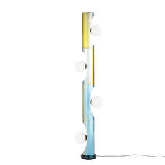 A floor lamp with a rainbow-colored design, featuring a series of round opal glass pieces mounted on a plated steel pole.