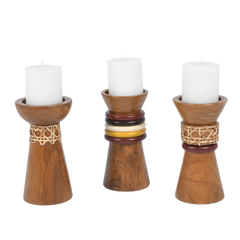 Troika Candle Holder, a set of three wooden candle holders with cane and decorative ring details, each holding a white candle.