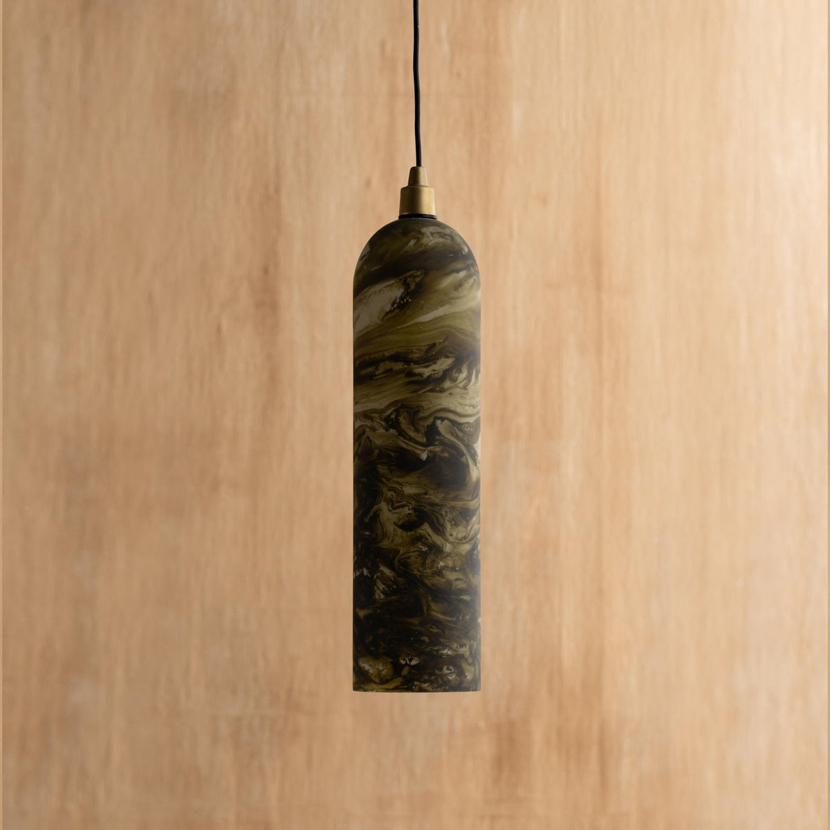 A green hanging lamp with a marble pattern, made from glass and mild steel, with a wooden background.