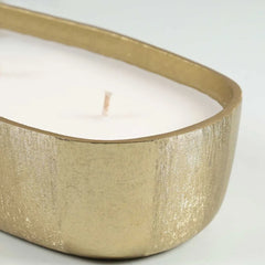Fleur Votive candle in a gold holder on a white background