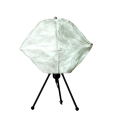 Designer table lamp with a tripod base and a braided cable, resembling the moon's surface, in a color close to white.