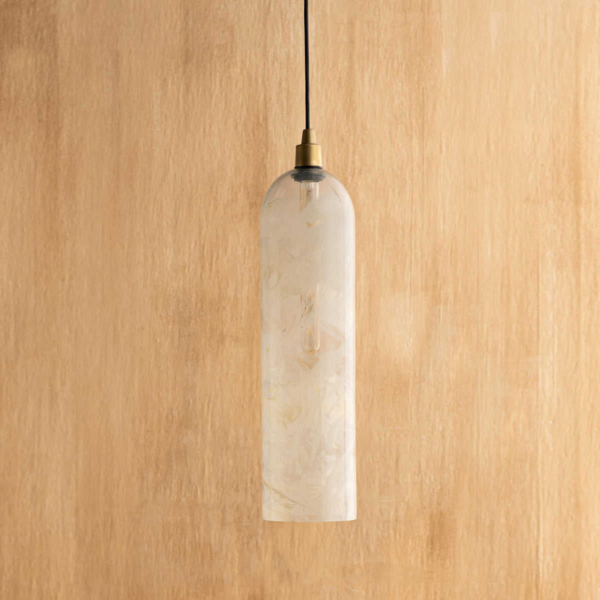 A white hanging pendant lamp with a marble-like pattern, made from glass and mild steel, with a simplistic and elegant cylindrical design.