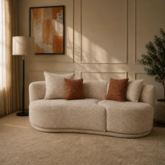 Velune 3 Seater Swivel Sofa in off-white boucle with cream and rust cushions in a panelled living room