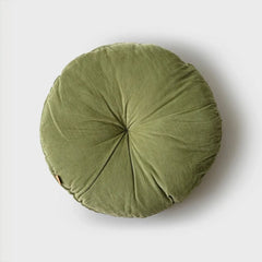 A round, olive green pouf cushion with a gathered, pleated design and a central button, shown from a top-down view.
