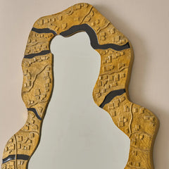 Unique design Kinara mirror with aluminium gold textured frame on a beige background