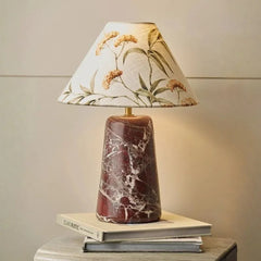Florence Table Lamp - Lit, Botanical Print Shade and Red Marble Base on Books