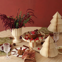Bow shape Rhubarb Velvet Napkin Rings with cake, crystal glass and paper trees, side angle
