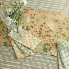 Valley Peach Linen Table Runner with checked napkins and white carnations, top view