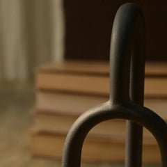 Close-up of a metal Aria Decor Sculpture with blurred steps in the background