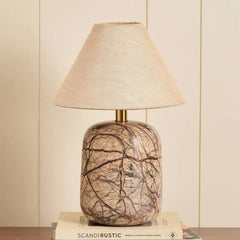 Dune Table Lamp - Front View, Rounded Marble Base with Brown Veining Against Panelled Wall