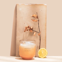 Abundant Universe Candle - Crystal Energy - Citrine Crystal, candle with lemon half and dried branch against a board