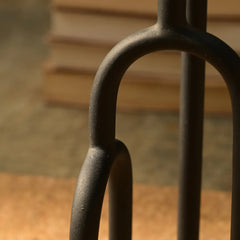 Close-up of a black metal Aria Decor Sculpture with a blurred background