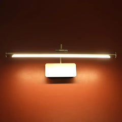 Decorative linear wall light fixture with a horizontal brushed metal bar and a rectangular frosted white diffuser, mounted on a dark reddish-brown wall and turned on, casting a warm glow.