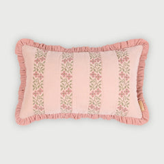 A rectangular pink decorative pillow with ruffled trim and vertical floral embroidered stripes, shown on a light gray background.