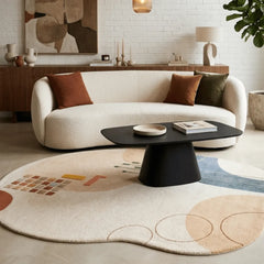 Modern living room with a white sofa, black coffee table, and abstract rug.