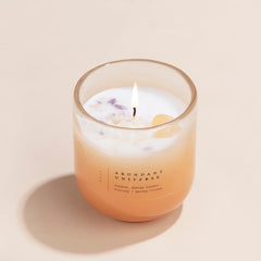 Abundant Universe Candle - Crystal Energy - Citrine Crystal, lit citrus ombre glass with crystal chips, front view