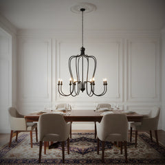 Dining room with a designer chandelier hanging above a table and chairs.