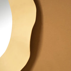 Close view of Ripple Mirror with wavy gold iron frame
