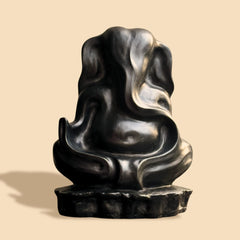 Decorative Black Ganesha Abstract Sculpture of a seated figure on a beige background