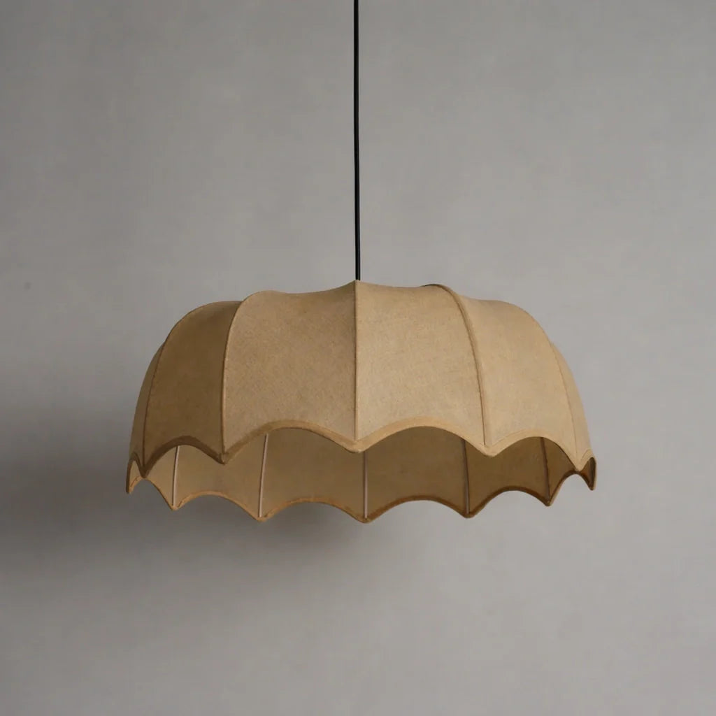 Beige pendant lamp with scalloped edge on a gray background