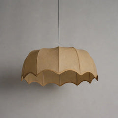 Beige pendant lamp with scalloped edge on a gray background