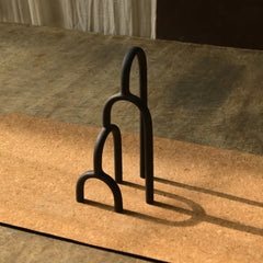 Aria Decor Sculpture, Two black metal horse stirrups on a stone surface