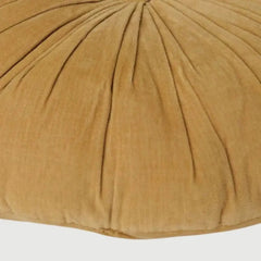 A close-up of a round, pleated pouf or cushion in a warm camel tan corduroy fabric, showing the texture and radial stitching details.