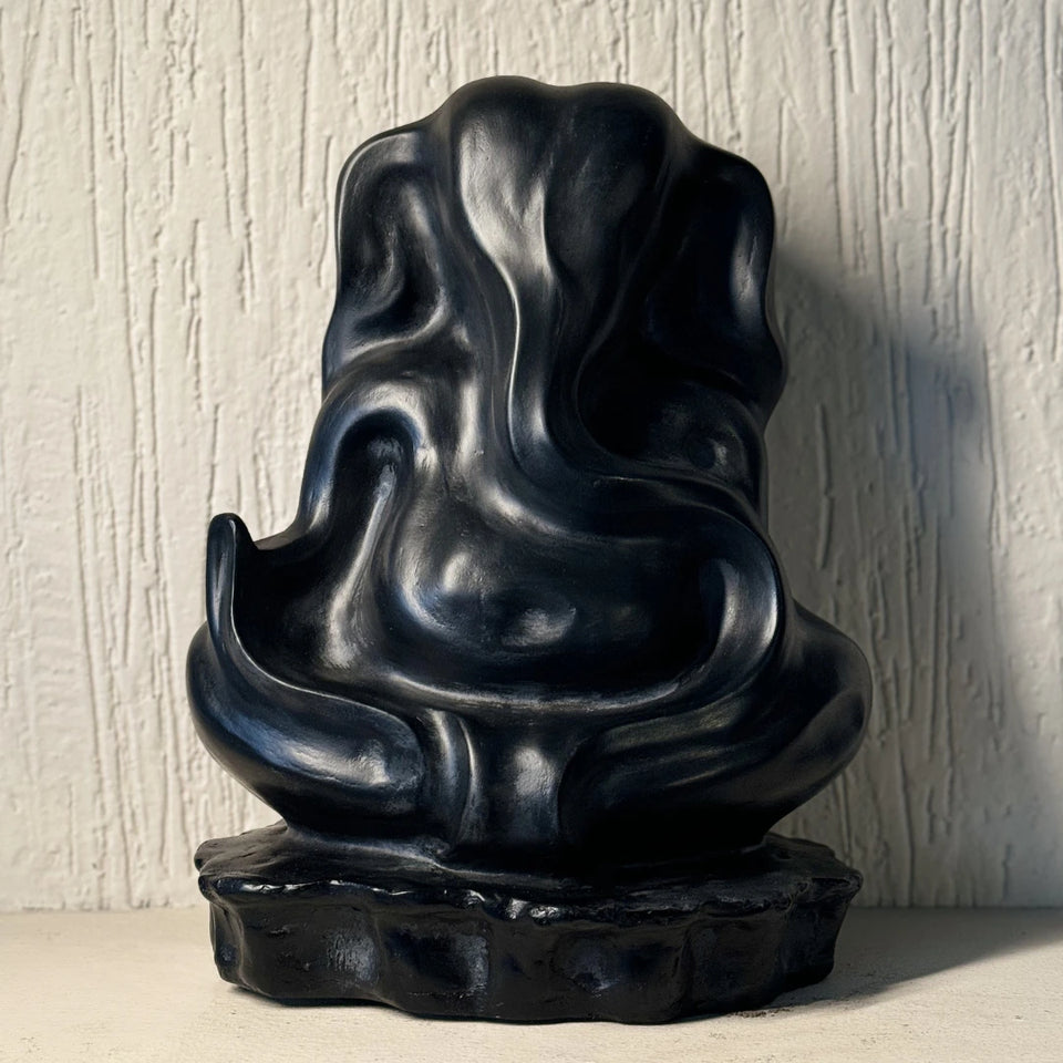 Black abstract Ganesha Sculpture on a textured surface