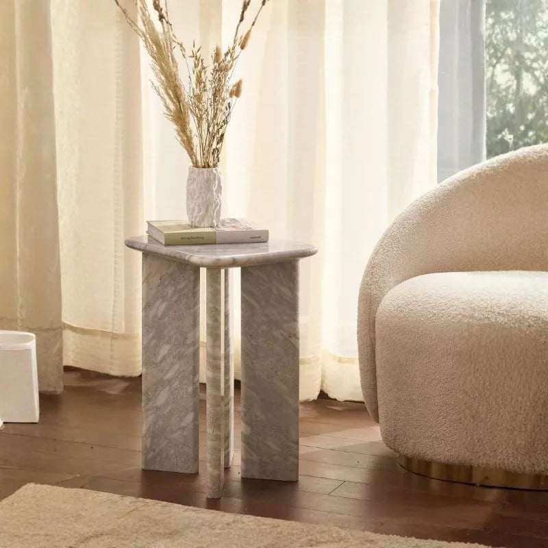 Orml Side Table - Grey Veined Marble Table with Vase and Books Beside Boucle Chair