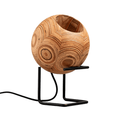 A round table lamp with a stand, featuring a textured wooden light fixture on a black metal stand, connected by a wire.