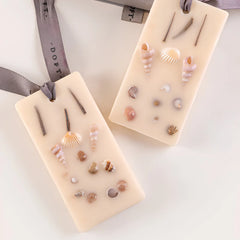 Venetian Bergamot - Wax Tablet, close-up of cream beeswax tablets set with seashells and twigs