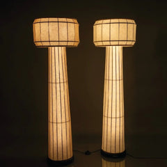Domus Floor Lamps with cylindrical shades and warm lighting on a dark background