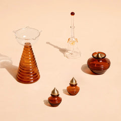 Composite Gift Box pieces, amber borosilicate glass tall diya, bell, kalash and mini kalash, top view