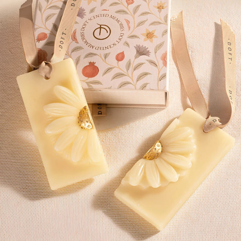 Whispering Jasmine - Wax Tablet, two cream tablets with raised daisy motif beside floral gift box