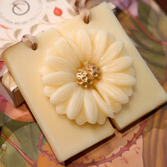 Whispering Jasmine - Wax Tablet, close-up of raised daisy with gold centre on cream beeswax