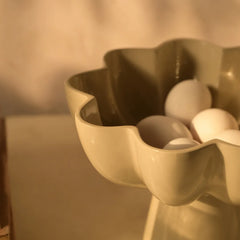 Decorative Sora Bowl made of aluminum with scalloped edge holding eggs against a neutral background
