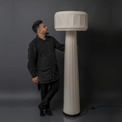 Person holding the Domus Floor Lamp to show scale and height
