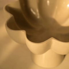 Close-up of a beige Sora Bowl with a wavy edge, made of metal