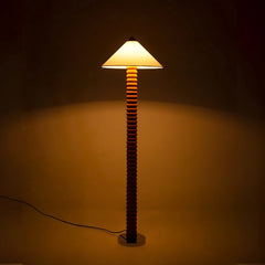 Terra Contour Tall floor lamp with textured base and white shade on a dark background