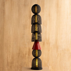 Decorative Totem Black Floor Lamp with stacked cylindrical shapes on a wooden background