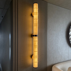 A Wall Sconce with vertical Australian marble tube and steel framework mounted on wall