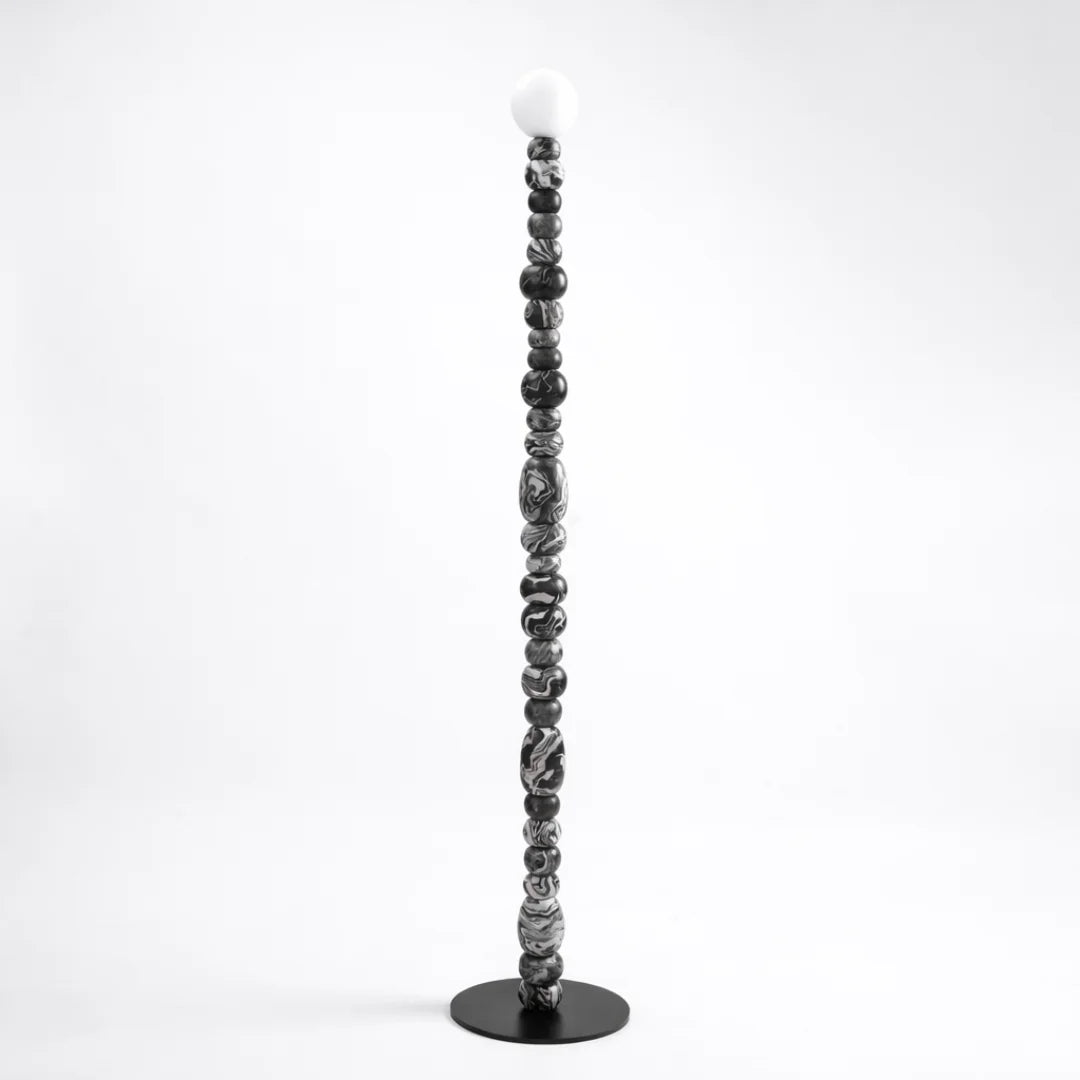 Align epoxy floor lamp with hand-rolled marbled spheres in a linear column