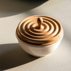Close view of Ripple Container, a handcrafted storage box with a white marble base and a natural wood lid with ripple design.