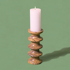 Decorative brown marble candle holder with a white candle